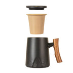 Black mug with wooden handle and beige travel mug on a white background