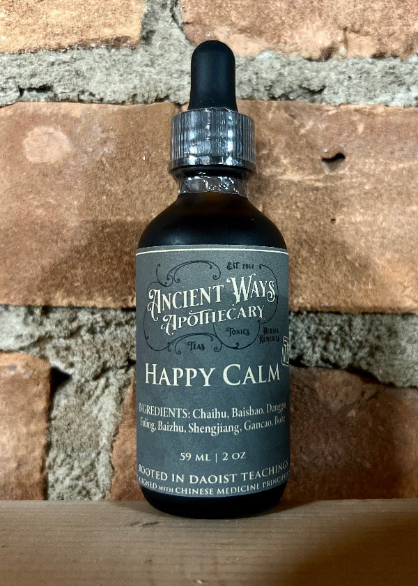 Bottle of 'Happy Calm' from Ancient Ways Apothecary against a brick wall background