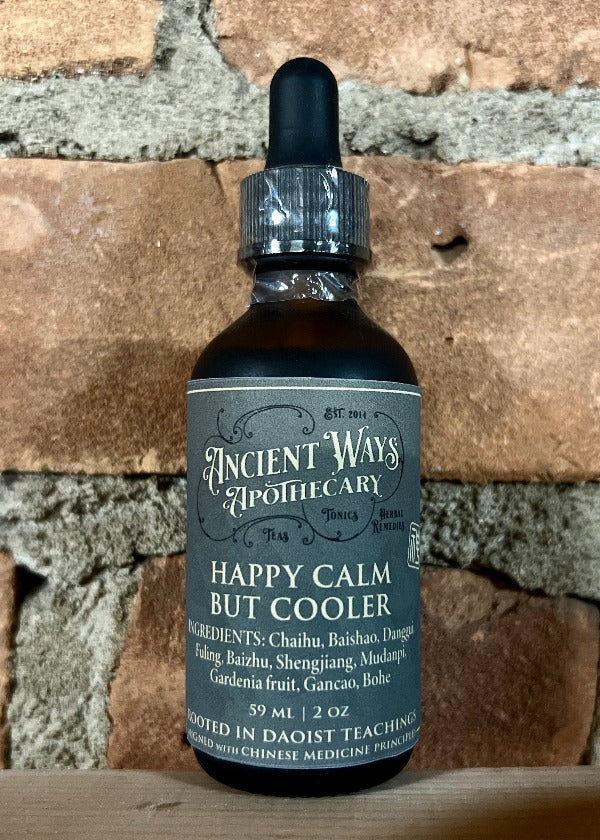 Bottle of 'Happy Calm But Cooler' from Ancient Ways Apothecary on a brick background