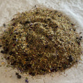 Loose Sweet Blueberry Bake rooibos tea blend with dried blueberry pieces and warm spiced fruit notes on parchment paper