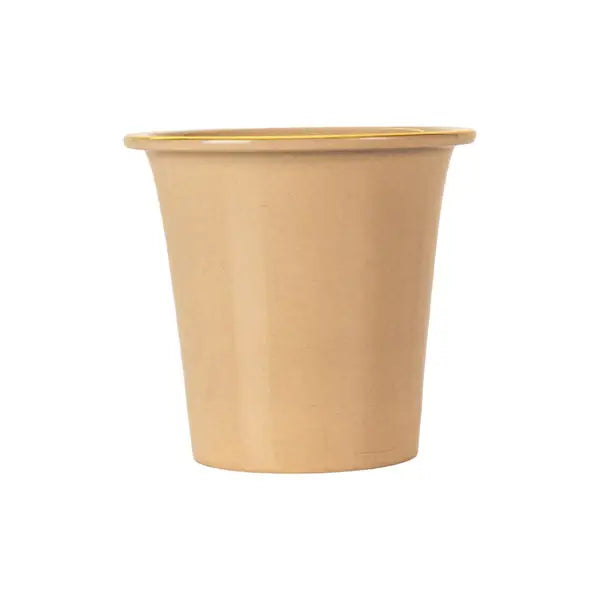 Beige ceramic tea strainer with gold rim on a white background